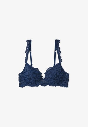 Marineblauer Spitzen-BH mit gepolsterten Cups, floralem Muster, gewellten Kanten und verstellbaren Trägern. Mit einer Schleifendetail in der Mitte.