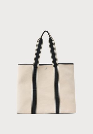 Beeži lõuendist kandekott mustade vertikaalsete triipude ja sangadega, kinnitatav keskmise nööpkinnitusega.