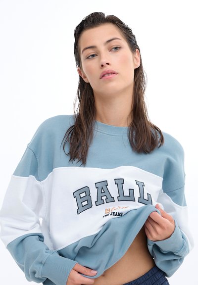 Blue and white color-blocked sweatshirt with "BALL" embroidered on the chest, featuring ribbed cuffs and a relaxed fit. Soft, smooth texture.