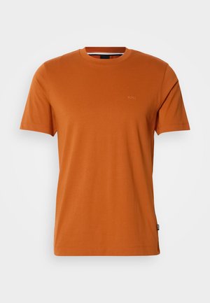 Kopparorange kortärmad t-shirt med rund halsringning och subtilt präglad logotyp på bröstet samt liten tygmärke på sidofsömmen.