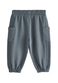 Grå joggingbukser med elastisk taljebånd, sidelommer og teksturerede sidepaneler, med rynkede manchetter ved anklerne.