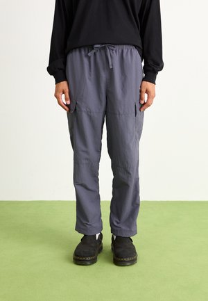 Gray cargo pants made of lightweight fabric, featuring an elastic waistband, two side pockets, and a relaxed fit.