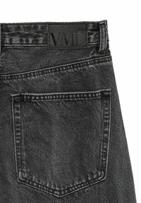 Jeans in denim nero con una patch rettangolare con logo "VMD", cuciture visibili e una tasca posteriore con design a patta appuntita.
