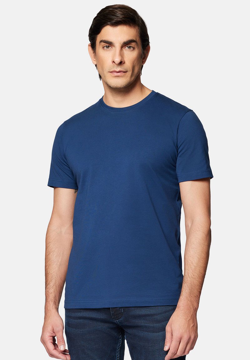 Granatowa bawełniana koszulka z krótkim rękawem i okrągłym dekoltem, o gładkiej fakturze i minimalistycznym designie.