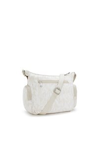 Borsa a spalla in tessuto bianco con motivo floreale, tracolla regolabile, tasca frontale con zip, zip laterale e forma tondeggiante. Texture con finitura liscia.