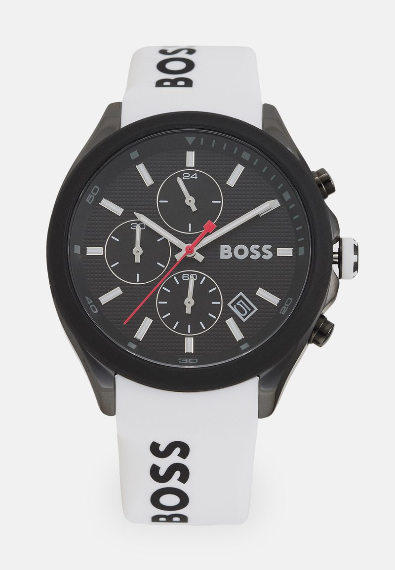 Black dial watch with three sub-dials, red accent, and white silicone strap featuring 'BOSS' logo, black case, and textured finish.