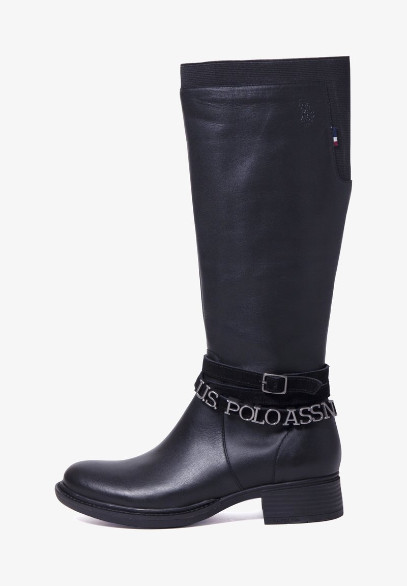Bottes noires montantes en cuir lisse avec une sangle en velours ornée de texte métallique, et un petit talon carré pour plus de stabilité.