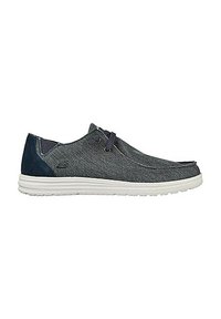 Zapatos grises casuales con parte superior de textil, suela de goma blanca, acentos azules y cordones decorativos. Punta redondeada y diseño de perfil minimalista.