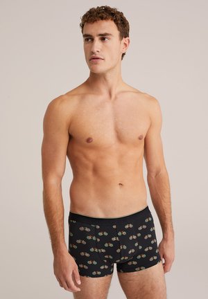 Caleçons noirs avec un motif de vélo en rouge, vert et or. Fabriqués en tissu doux avec une coupe ajustée et une taille élastique.
