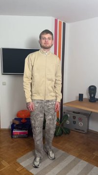 Beige zip-up jacket, grey camouflage cargo pants, and light sneakers. Smooth fabric texture, relaxed fit, with side pockets on pants.