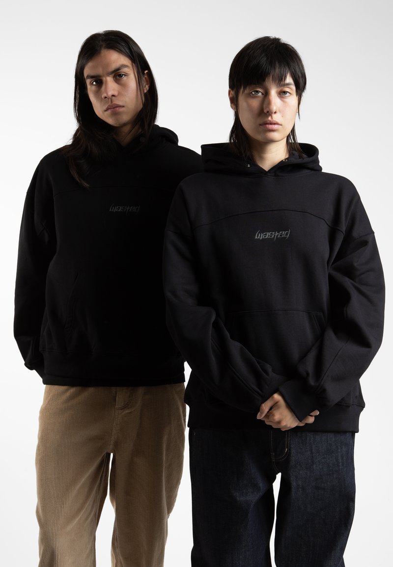 Black hooded sweatshirts feature a textured finish with a minimal design. One with a large pocket and both have logo accents on the chest.