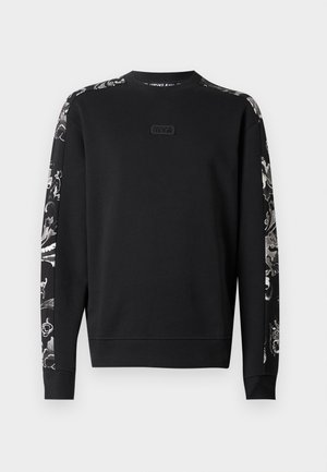 Sweatshirt noir avec un tissu texturé, col rond et manches à motifs contrastés avec des motifs floraux. Logo discret sur la poitrine.