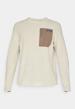 Ljuscremefärgad långärmad skjorta med en strukturerad zigzagstruktur. Har en brun bröstficka med dragkedjestängning och en logotypmärke.