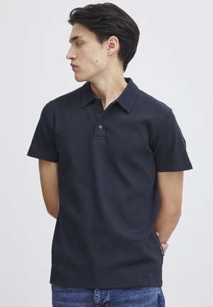 Navy short-sleeve polo shirt with a textured fabric, featuring a collar, three button placket, and a straight hem.