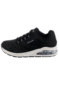 Black athletic sneakers with a textured leopard print, padded collar, and clear air cushioning in the heel. Features white rubber sole.