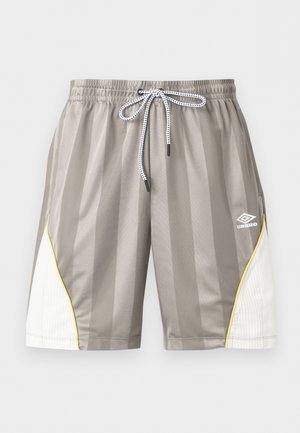 Hallid spordipüksid vertikaalsete triipudega, valged külgpaneelid kollase äärisega, elastne vöökoht, nöörpael ja Umbro logo paremal jalal.