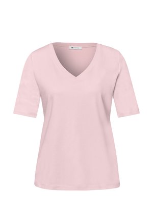 Chemise rose pâle à manches courtes avec col en V et ourlet droit, présentée sur un fond blanc.
