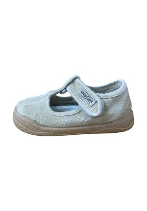 Zapato infantil Mary Jane de tela beige con tira ajustable de Velcro etiquetada como "Zapyflex" y suela de goma marrón texturizada.