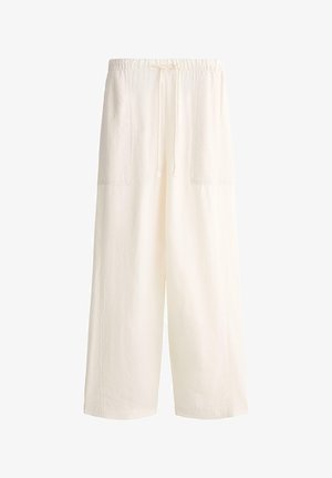 Krémové nohavice s širokými nohavicami, s elastickým pásom a šnúrkou, s veľkými prednými náprsnými vreckami a voľným strihom.