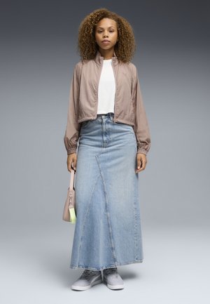 Light pink bomber jacket, white t-shirt, long blue denim skirt with a diagonal seam, gray sneakers, and a pink bag with a neon strap.