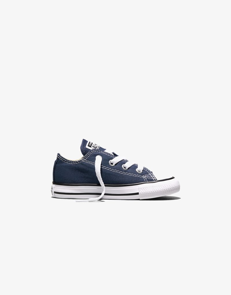 Navy blue low-top canvas sneaker with white rubber toe, white laces, and black stripe on white sole, viewed from the side on white background.
