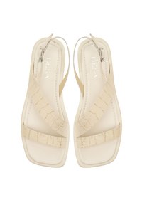 Beige sandals with a smooth texture, featuring crisscross straps and a square toe design, with a small adjustable buckle detail.