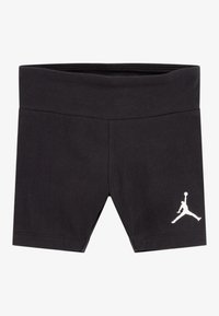 Shorts de sport noirs avec une taille large, arborant un logo Jumpman blanc sur le bas de la jambe gauche.