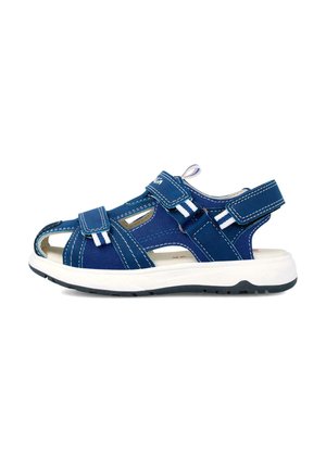 Sandalia de lona azul con punta abierta, dos correas ajustables, costuras blancas y suela blanca con un fondo texturizado para mayor agarre.