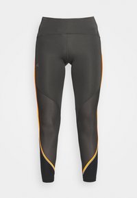 Czarne legginsy sportowe z pomarańczowymi akcentami po bokach, wykonane z elastycznego materiału. Charakteryzują się wysokim stanem i dopasowanym krojem.