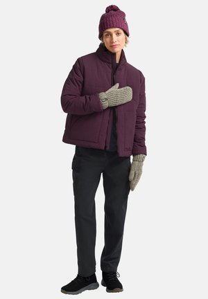 Maroon puffer jacket, knit beanie, gray textured mittens, black pants, and dark sneakers. The jacket features a zip closure and a boxy cut.