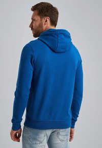 Blue hoodie with a drawstring hood, ribbed cuffs, and hem. Made from soft material, featuring a smooth texture and a fitted design.