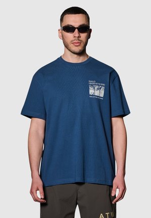 Navyblauwe katoenen T-shirt met een losse pasvorm, ronde halslijn en korte mouwen. Voorzien van een grafische print op het linker borstgebied.