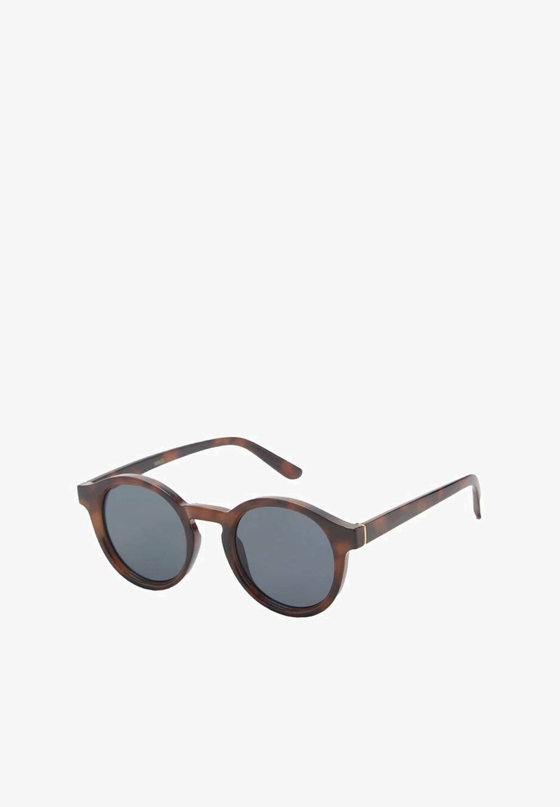 Round sunglasses in a tortoiseshell pattern with dark lenses; features slender arms and subtle gold accents on the frame.
