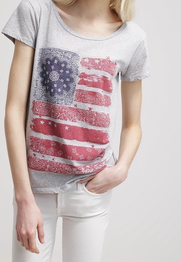 Gray cotton t-shirt featuring a distressed graphic print of the American flag in red, white, and blue with paisley accents.