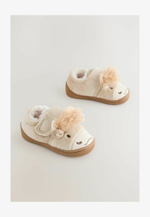 Pantoufles en peluche beige avec un intérieur crème doux, ornées d'un design de visage de lion, d'une crinière texturée et d'une fermeture Velcro. Semelles en caoutchouc marron.