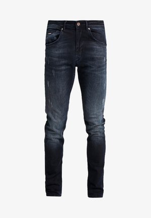Donkerblauwe spijkerbroek met een slim fit, voorzien van lichte vervaging en wassingdetails aan de voorkant, vijf zakken en metalen hardware.