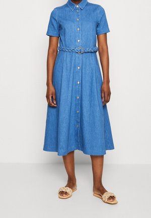 Collared, short-sleeve blue denim midi dress with button front and braided belt, worn with beige woven slide sandals.