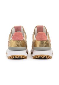 Sneakers featuring a gold metallic back, pink suede accents, white midsole, and textured rubber outsole with protruding nubs for traction.