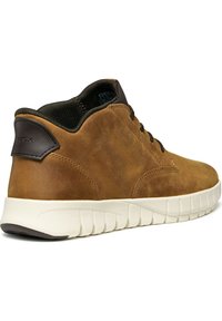 Brown leather high-top sneaker with a black fabric lining and white rubber sole. Features a rounded toe and prominent stitching details.