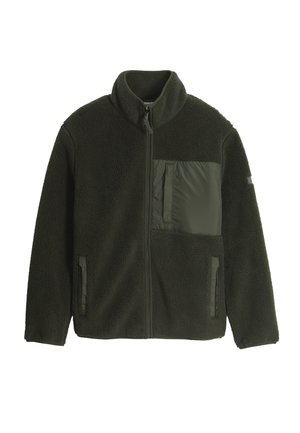 Veste polaire vert foncé avec fermeture éclair intégrale à l'avant, col haut, deux poches latérales basses et une poche en nylon sur la poitrine côté gauche.
