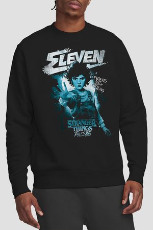 Man wearing black sweatshirt with graphic of Eleven from Stranger Things, hand extended, text "Friends Help Friends" and "Tales from '85."