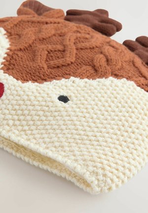 Gebreide deken met een crèmekleurige basis en textuurpatronen in crèmekleur en bruin, inclusief een bruine bovenkant die lijkt op dierlijke kenmerken.