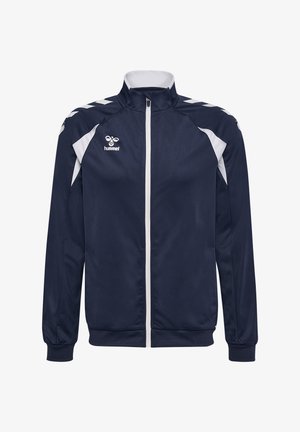 Marineblauwe en witte trainingsjas met volledige ritssluiting aan de voorkant, hoge kraag, witte chevronstrepen op de schouders en Hummel-logo op de borst.