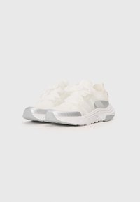 White athletic shoes with a breathable mesh upper, sleek design, reflective silver accents on the sides, and textured rubber sole.