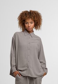 Gray button-up shirt with a collar, long sleeves, and a relaxed fit, featuring soft fabric and subtle texture.