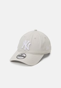 Light gray baseball cap with white embroidered logo, curved brim, adjustable strap, and breathable fabric panels. Features logo stitching on the side.