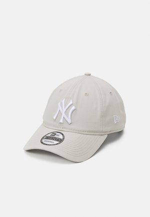 Light gray baseball cap with white embroidered logo, curved brim, adjustable strap, and breathable fabric panels. Features logo stitching on the side.