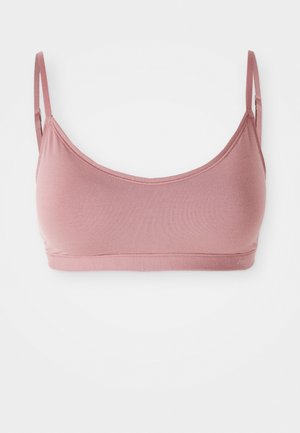 Bralette en coton rose avec des bretelles fines et une texture lisse. Design simple et sans coutures avec une forme douce et ajustée, sans rembourrage.