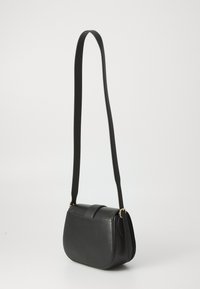 Black crossbody bag made of textured leather with a curved shape, adjustable strap, and gold-tone hardware. Features minimalist design.