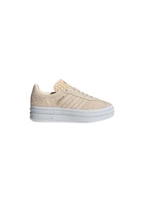 Beige sneakers with a textured suede upper, featuring three white stripes, a woven tongue, and a chunky white rubber sole.